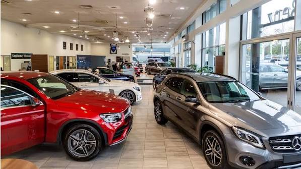Cars on display inside a bright dealership showroom